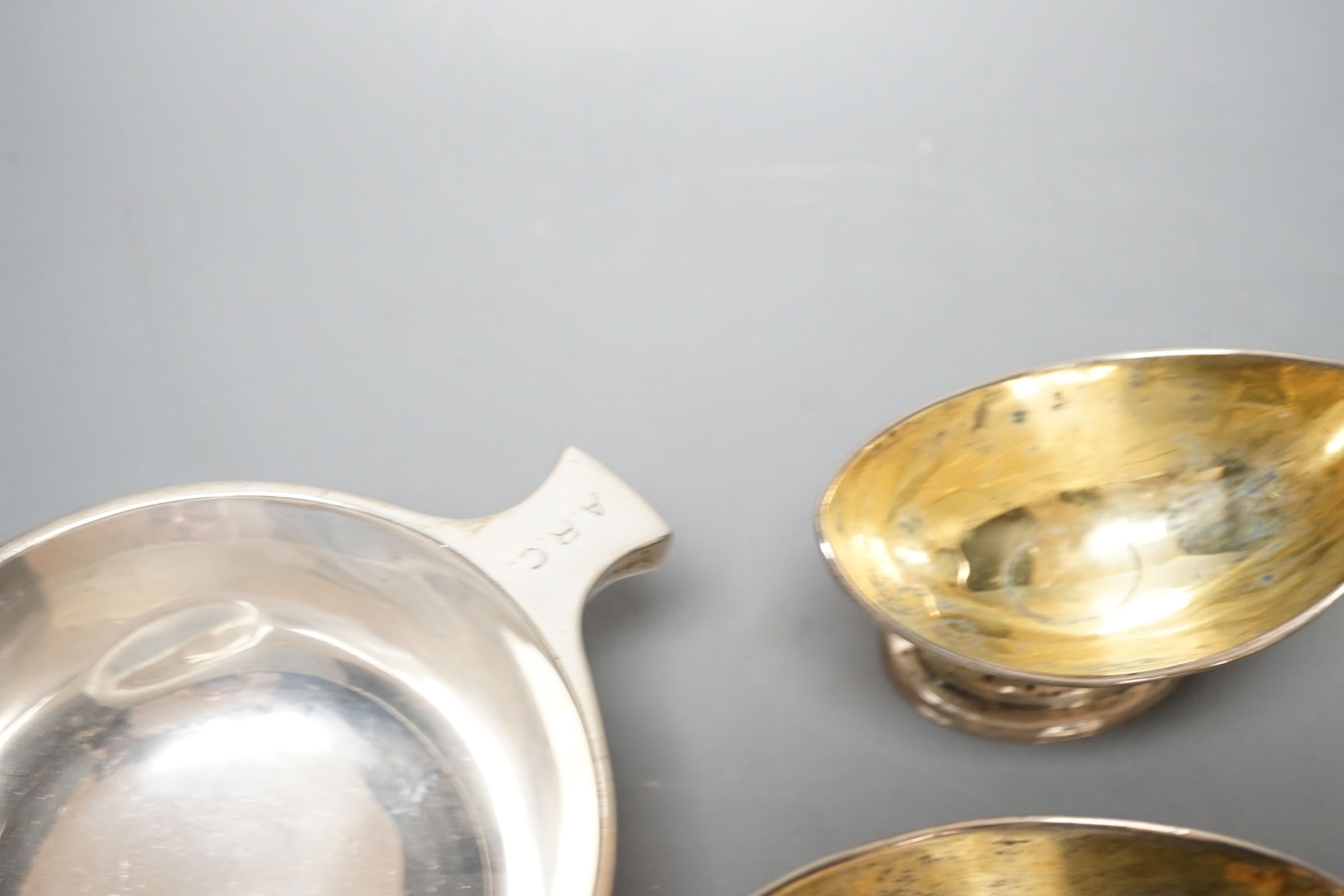 A mixed collection of silver to include a Scottish quaich, a pair of George III boat shaped salts, a George III silver helmet shaped cream jug and a pierced boat-shaped bowl, 17oz.